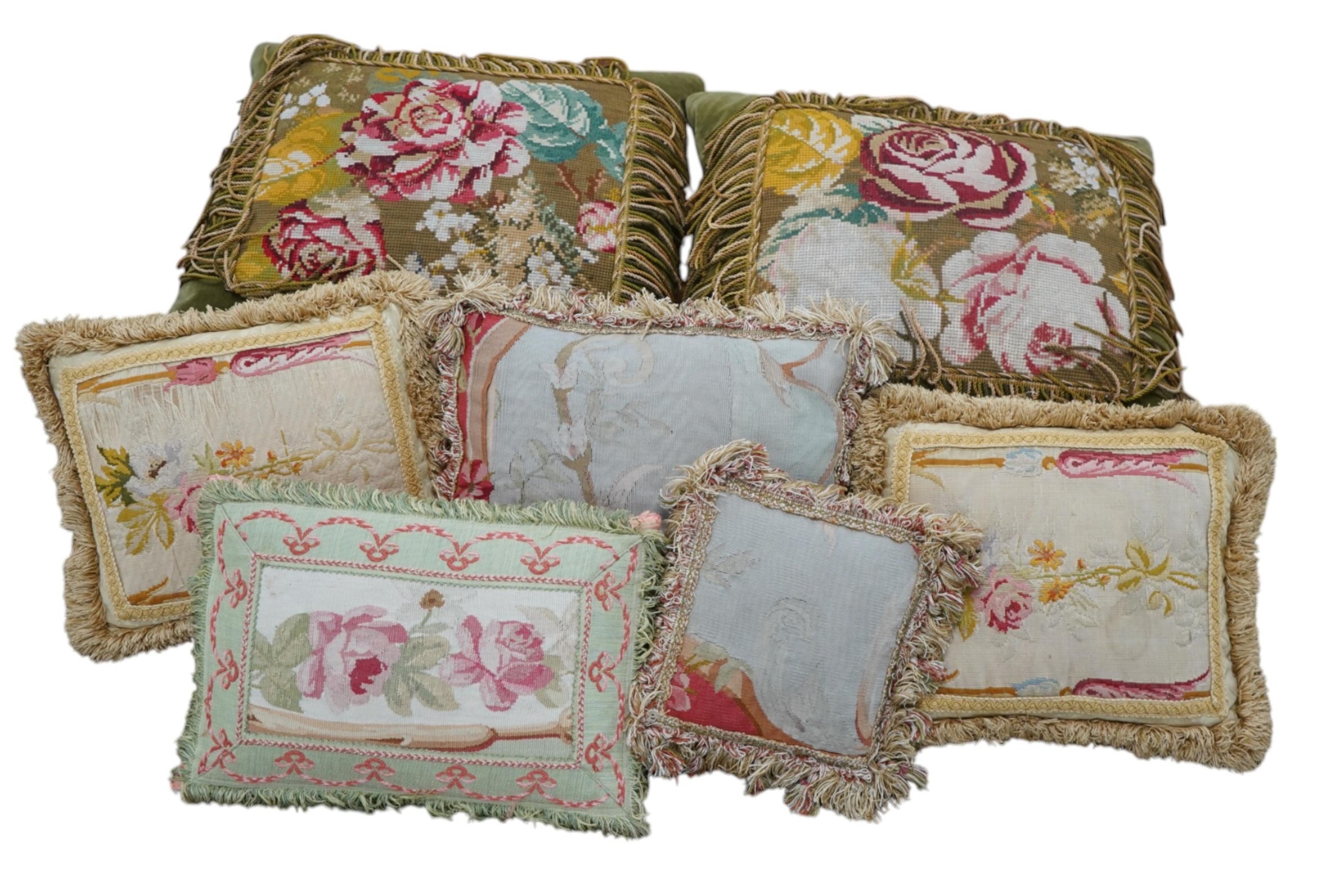 Seven 19th century cushions. Three Aubusson tapestry cushions and two machine Aubusson cushions, together with two floral wool worked cushions, all with decorative fringing. Largest 40cm x 45cm. condition - three are wor